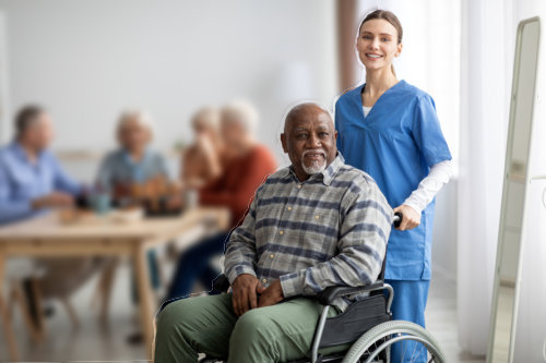 senior patient on wheelchair with female nurse smiling